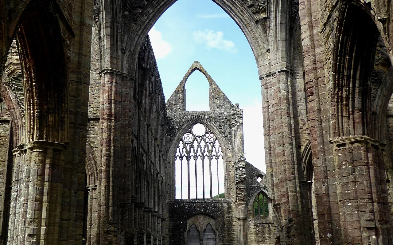 Looking down the roofless nave of Tintern Abbey to open sky